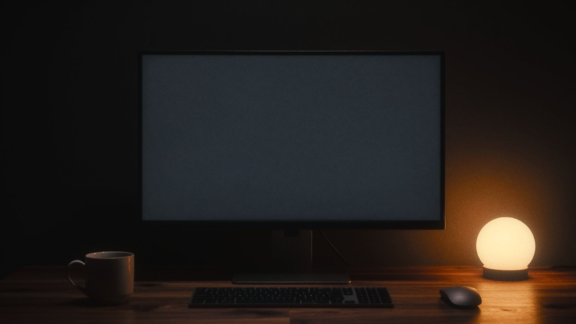Un escritorio de noche, con la pantalla y una lámpara de esfera naranja como únicas luces. En el monitor se construye la portada de Kalabs en tres pasos: el boceto, la estructura y la portada terminada, con el lago y la esfera.